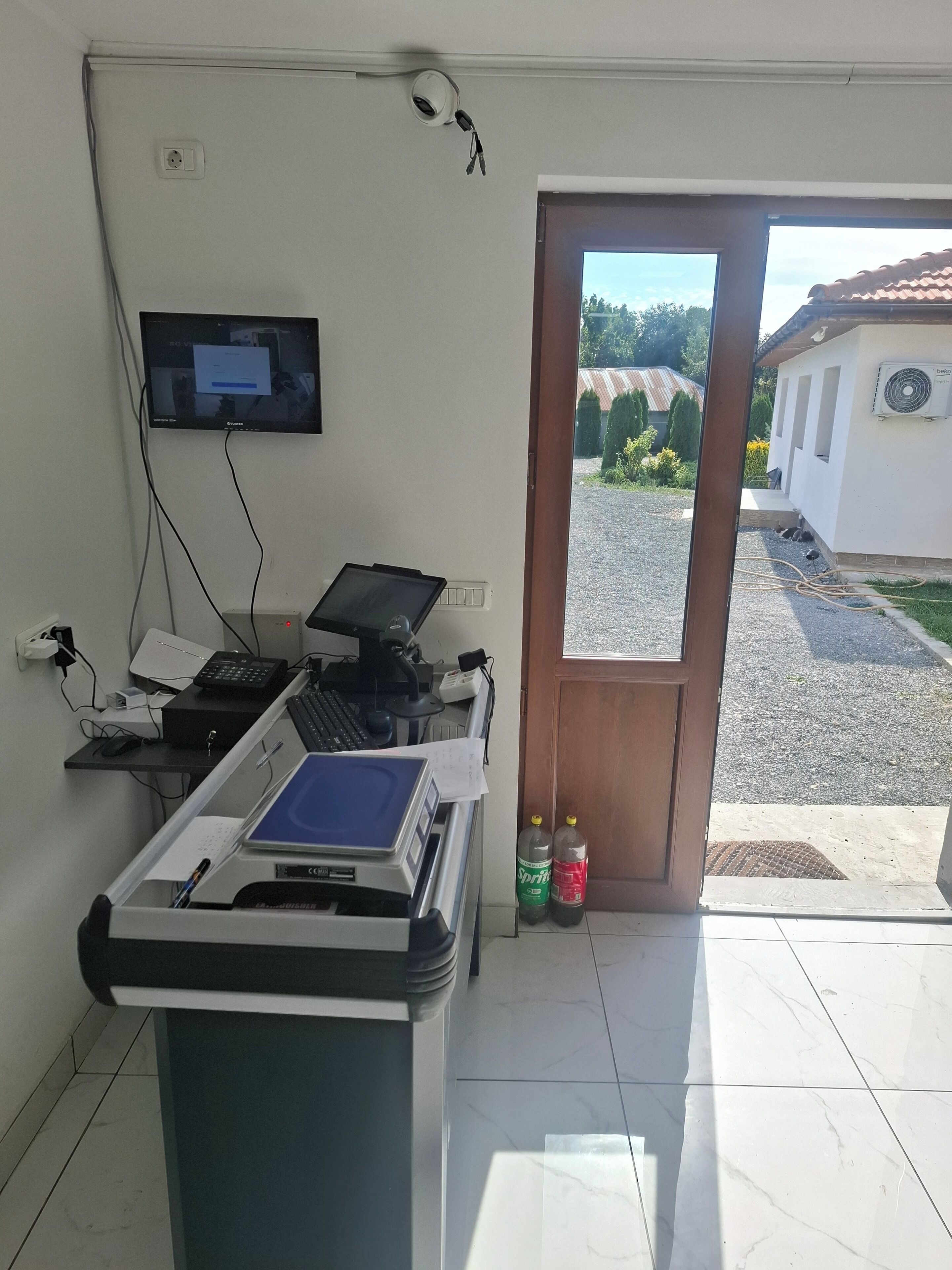 A room with a desk, computer, and a view of the outside.