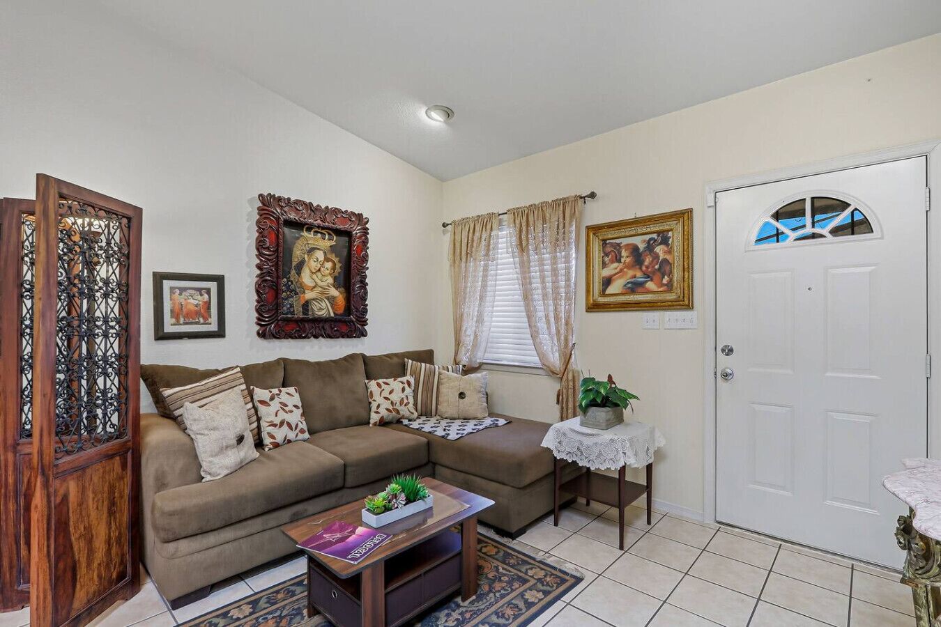 A living room with a sofa, a coffee table, and a door.