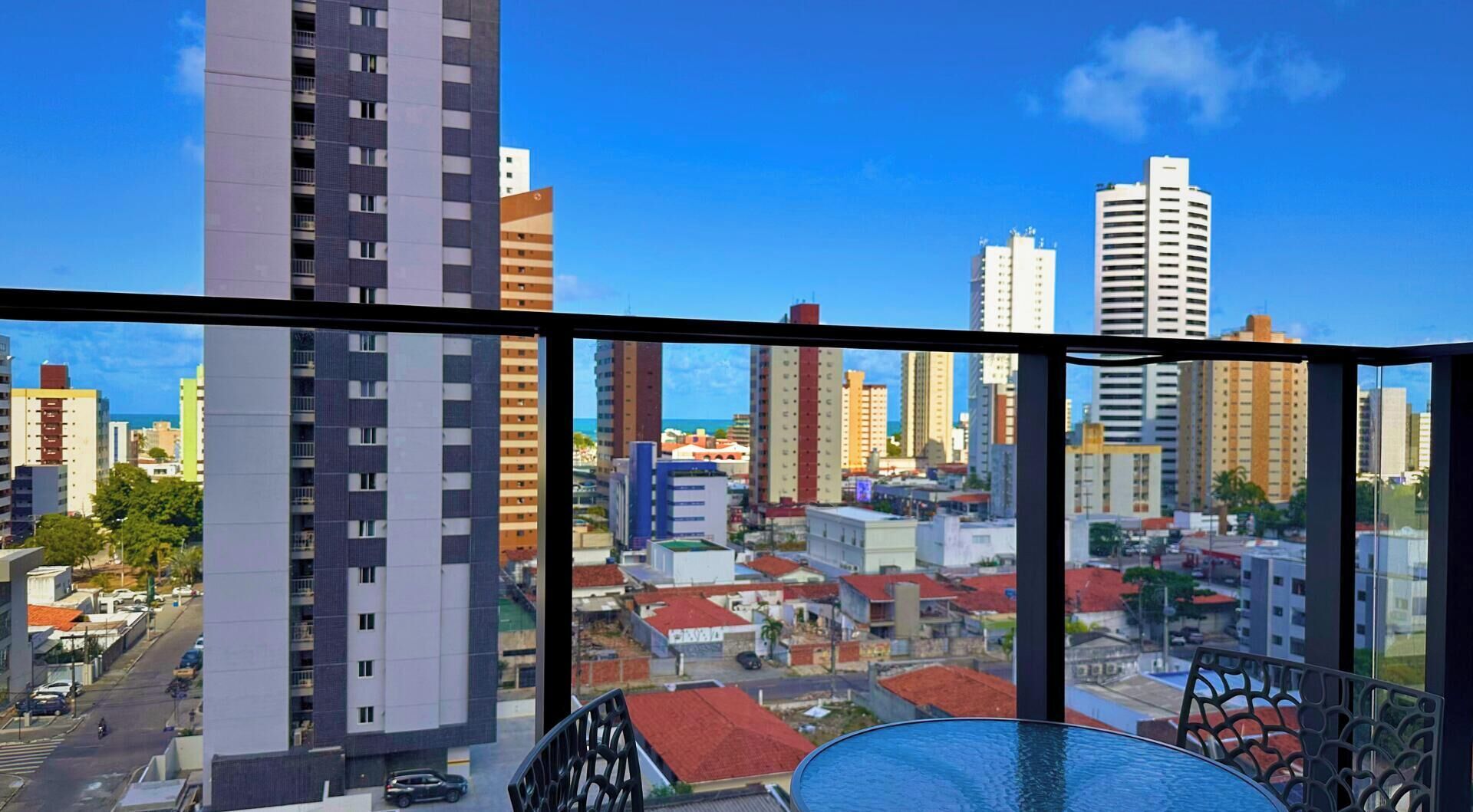 A high-rise building with a view of a cityscape through large windows.