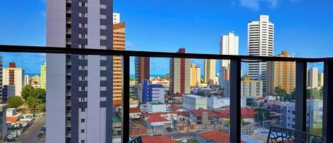 A high-rise building with a view of a cityscape through large windows.