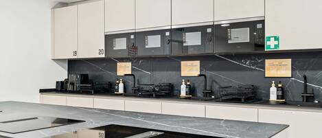 Modern Shared Kitchen with Island – Cook and connect in this sleek, fully equipped kitchen featuring premium appliances and a spacious island.