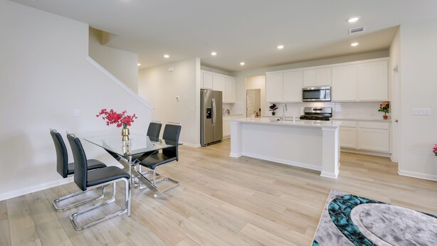 A modern kitchen with white cabinetry, stainless steel appliances, and a central island. - Buda Business-Ready House: Office, Home Gym & Yard (Buda)