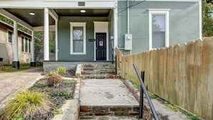 A two-story house with a covered porch, a front door, and a mailbox. - Park Avenue Retreat (Hot Springs)