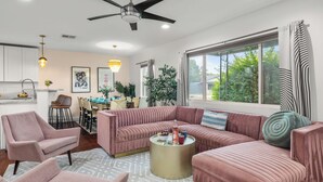 A modern living room with a sofa, armchairs, a coffee table, and a dining area with chairs and a table. - Scottsdale Retreat w/ Private Pool, Outdoor Dining & Close to Old Town Fun Casa Cambridge by Avantstay (Scottsdale)