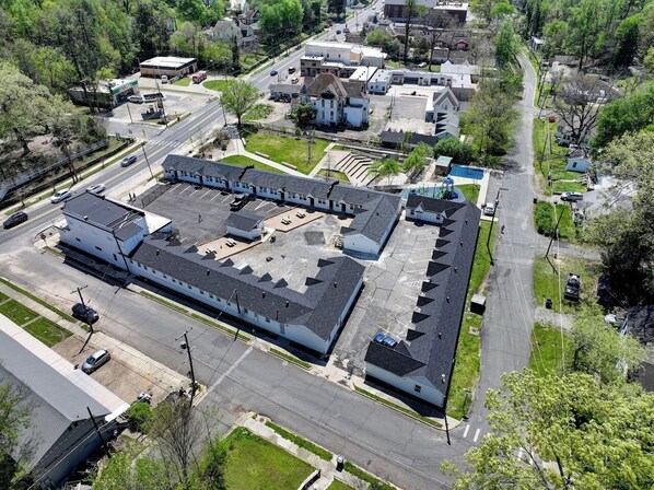 An aerial view of a large industrial building with multiple parking lots and a central courtyard. - The Belmont at PWC (Hot Springs)