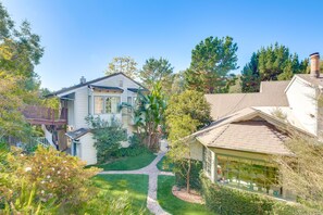 A residential property with a well-maintained lawn, a brick pathway, and a detached garage. - Quiet LA Retreat with Pool and Patio (Los Angeles)
