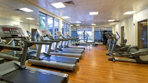A gym with multiple treadmills and elliptical machines, large windows, and a wooden floor. - Chevron Renaissance - 2 Bed 1 bath Low Floor - 1098 - 2 night - Chevron 2 Bedroom 1 Bathroom Apartment (Surfers Paradise)