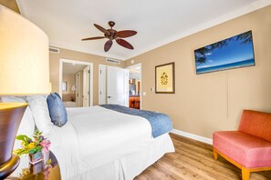 A hotel room with a bed, a ceiling fan, a TV, a chair, and a painting on the wall. - 2 Honua Kai Villas | Ocean View | Sleeps 10 | Free Car w/ 6+ Nights | ML-2528 (Lahaina)