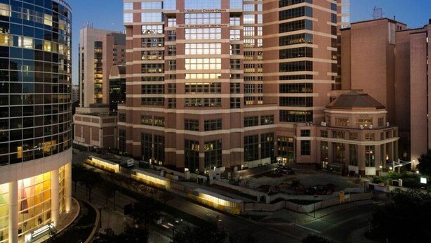 A multi-story building with a modern architectural design, featuring a prominent glass facade and a mix of brick and glass materials. - Tangerine 2Bed 2Bath at 5 min walk to NRG near TMC (Houston)