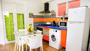 A compact kitchen with a washing machine, microwave, and a refrigerator. - Just like home, private swimming pool not overlooked (Rivière-Salée)