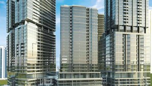A modern high-rise building with multiple floors, large glass windows, and a waterfront location. - Radiant Boulevard by DVH Luxe Retreats (Abu Dhabi)