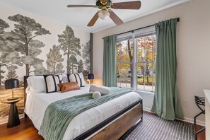 Cozy bedroom with queen bed, desk, smart TV, and bright natural light. - Playhaus Poconos - Sauna, Hottub, Arcade, Karaoke (Tobyhanna)