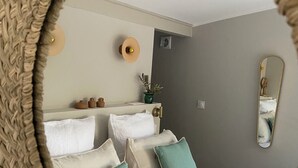 A bedroom with a bed, pillows, a nightstand, a mirror, and a wall-mounted light fixture. - Mas Tihou charming Provencal estate✨& Nordic bath 🫧 (Le Beausset)