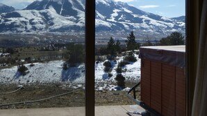 A view through a window of a mountainous landscape with snow-covered peaks and a clear sky. - Adorable Montana Cabin by Yellowstone! (Emigrant)