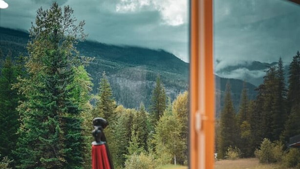 A room with a large window overlooking a mountainous landscape. - Secluded Retreat | Pool,HotTub,Sauna,Firepit,Views (Meadow Creek)
