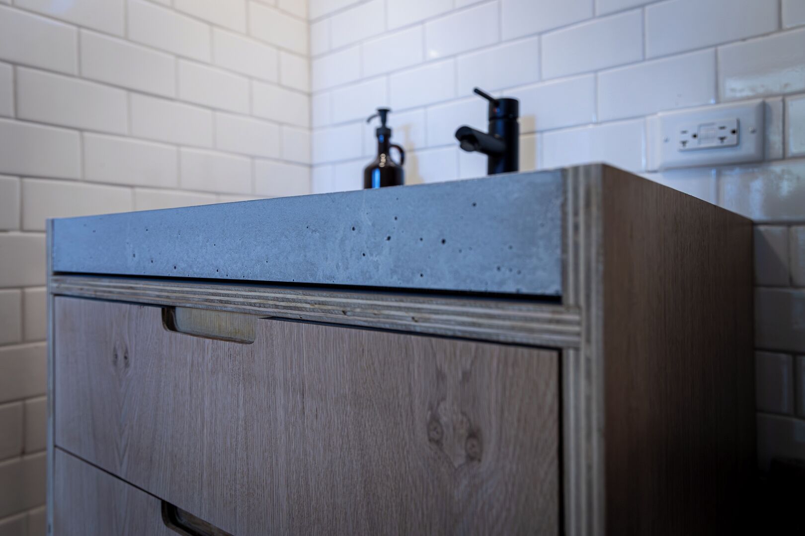 A wooden cabinet with a drawer and a countertop.