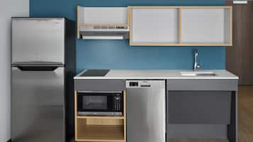 A modern kitchen with a built-in refrigerator, microwave, and dishwasher.