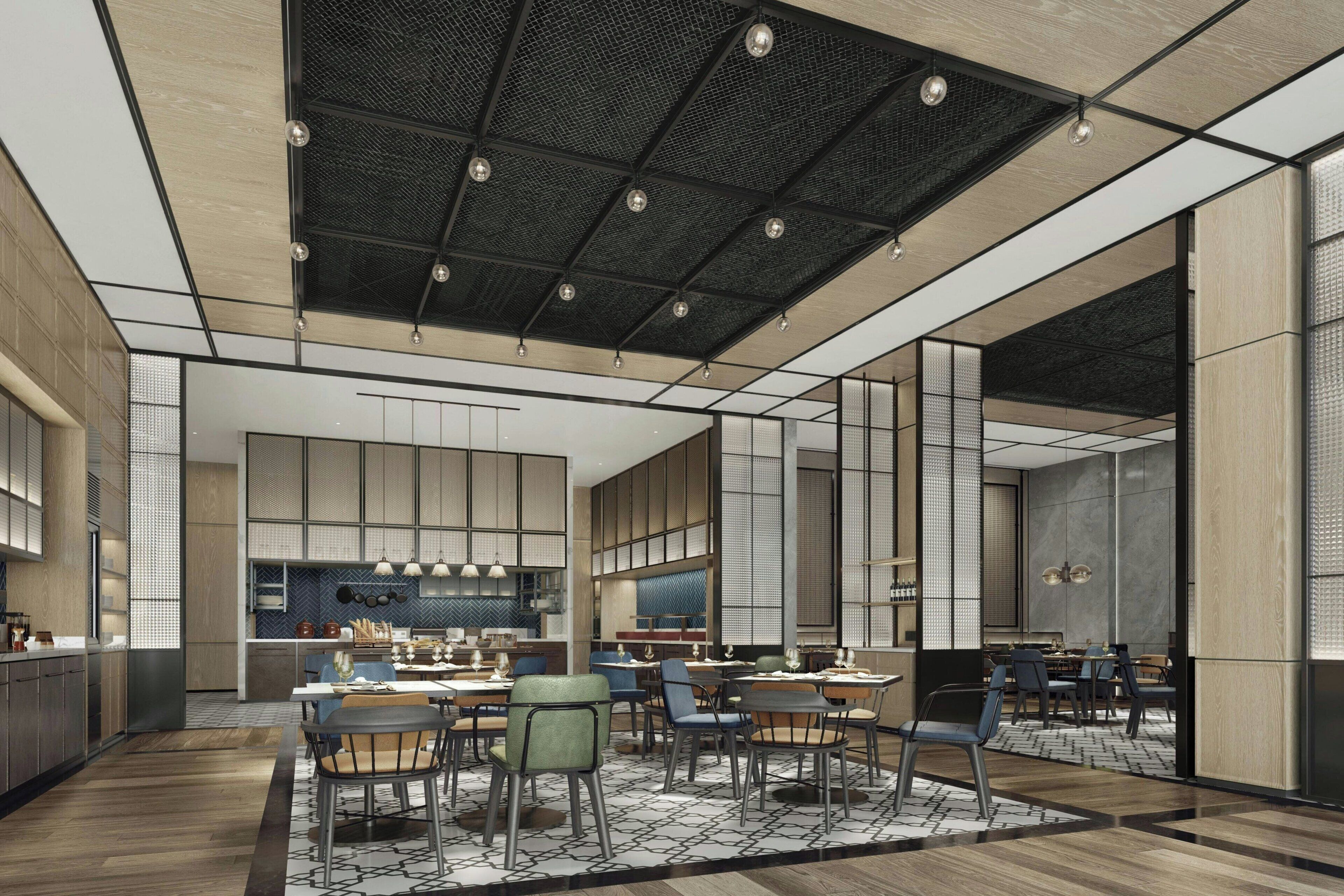 A modern interior with a dining area, kitchen, and seating arrangements.