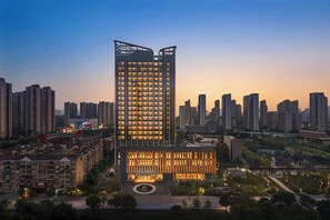 A high-rise hotel with a modern design, featuring a prominent entrance and multiple floors. - Four Points By Sheraton Wuhan, Dongxihu (Wuhan)