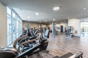 A gym with treadmills, elliptical machines, and weight equipment.