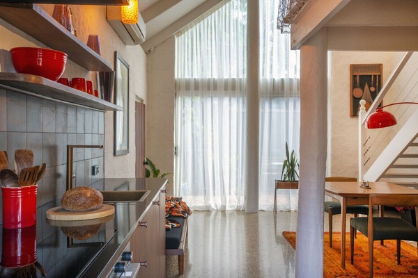 A-frame windows set the scene for a relaxed stay, flooding the space with natural light and a sense of calm.
