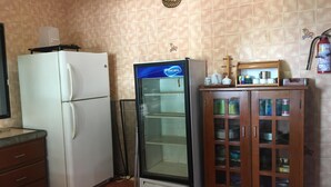 A kitchen with a white refrigerator, a glass-fronted freezer, and a wooden cabinet with glass doors. -  Beach Front House in Tránsito Beach , 5-Bedrooms, AC ,with Beachfront  Pool. (El Tránsito)