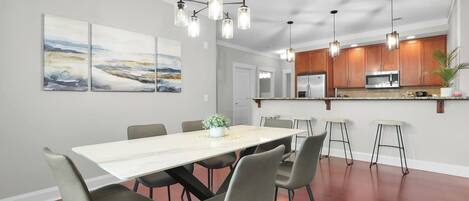 A modern kitchen with wooden cabinets, stainless steel appliances, and a central island.
