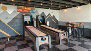 A bowling alley with two lanes, a neon sign, and a bar area. - Cozy Ranch King Bed & Pet Friendly - Fenced Yard (Gahanna)