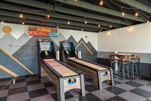 A bowling alley with two lanes, a neon sign, and a bar area. - Cozy Ranch King Bed & Pet Friendly - Fenced Yard (Gahanna)
