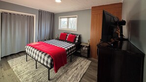 A bedroom with a bed, a TV, a window, and a ceiling with recessed lighting. - 3BR Less then 5 minutes from Downtown, Hospitals & Mall (St. John's)