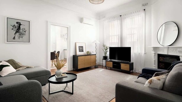 A modern living room with a sofa, a coffee table, a TV, and a fireplace. - Charming 2Bed Home Near Cafés & Racecourse (Hamilton)