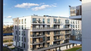 A modern multi-story building with balconies, large windows, and a well-maintained lawn. - Starowiejska 91 Superior Apartment (Gdańsk)