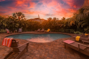 A swimming pool with lounge chairs and a brick patio. - Perfect for large groups, Steps to the Beach. Private Pool & Putting Green. (Siesta Key)