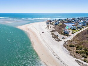 An aerial view of a coastal area with a beach, houses, and a small body of water. - Point of View- Beachfront, dog-friendly 4-BR townhome with unbeatable views (North Topsail Beach)