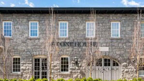 A stone building with the name "STONEHOUSE" on the facade, featuring multiple windows and a gated entrance. - Sonoma Stonehouse, King Room w/ Private Patio (Santa Rosa)