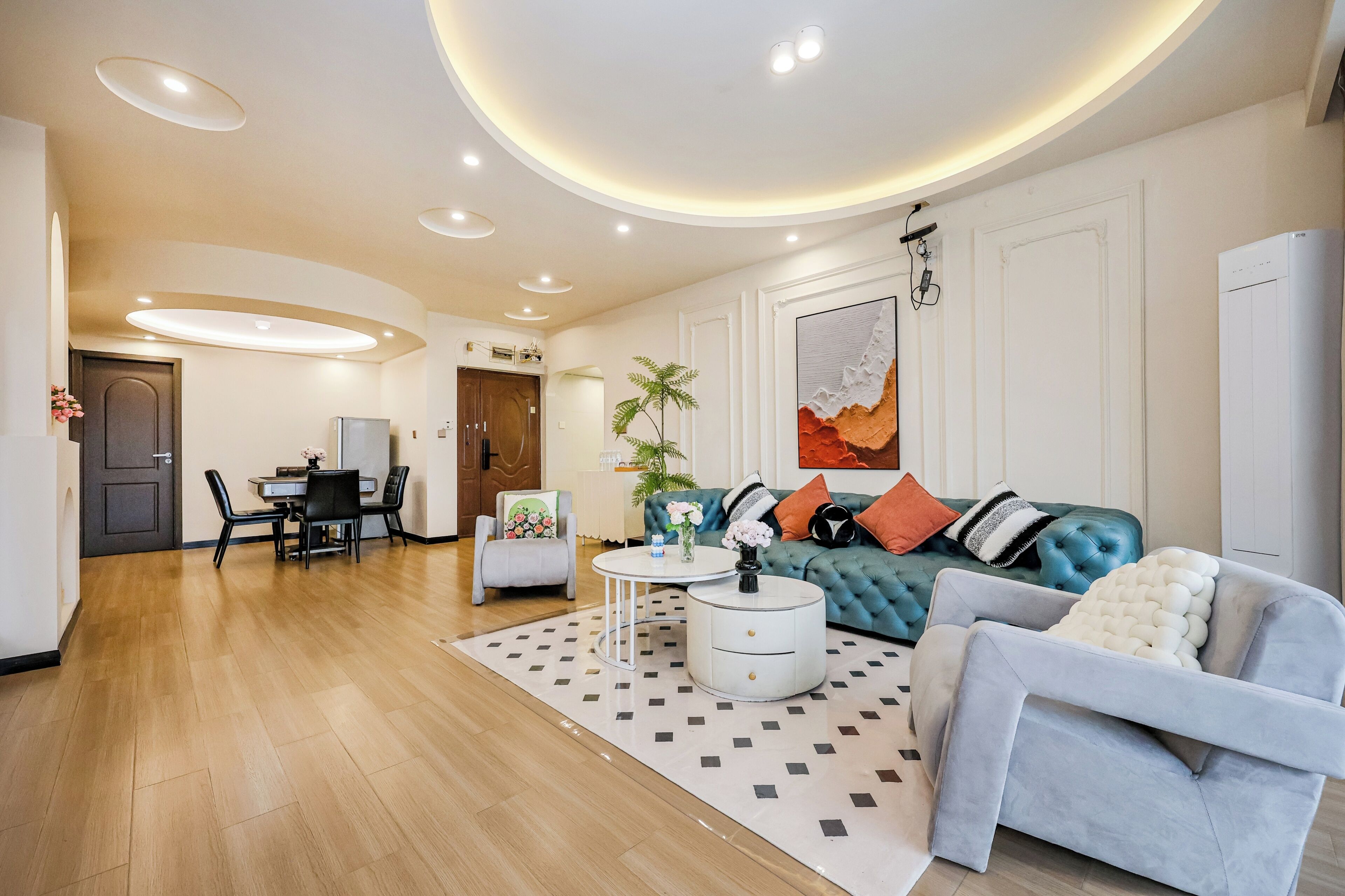 A modern living room with a sofa, a dining table, and a coffee table.