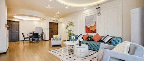 A modern living room with a sofa, a dining table, and a coffee table.