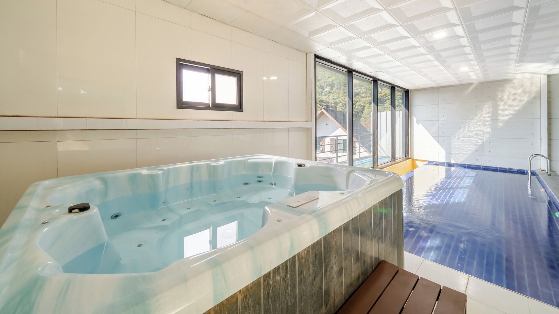 A spa area with a hot tub and a pool.