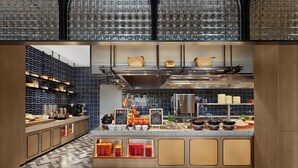 A modern kitchen with a central island, stainless steel appliances, and a patterned backsplash. - Dhawa Beihai Weizhou Island (Beihai)