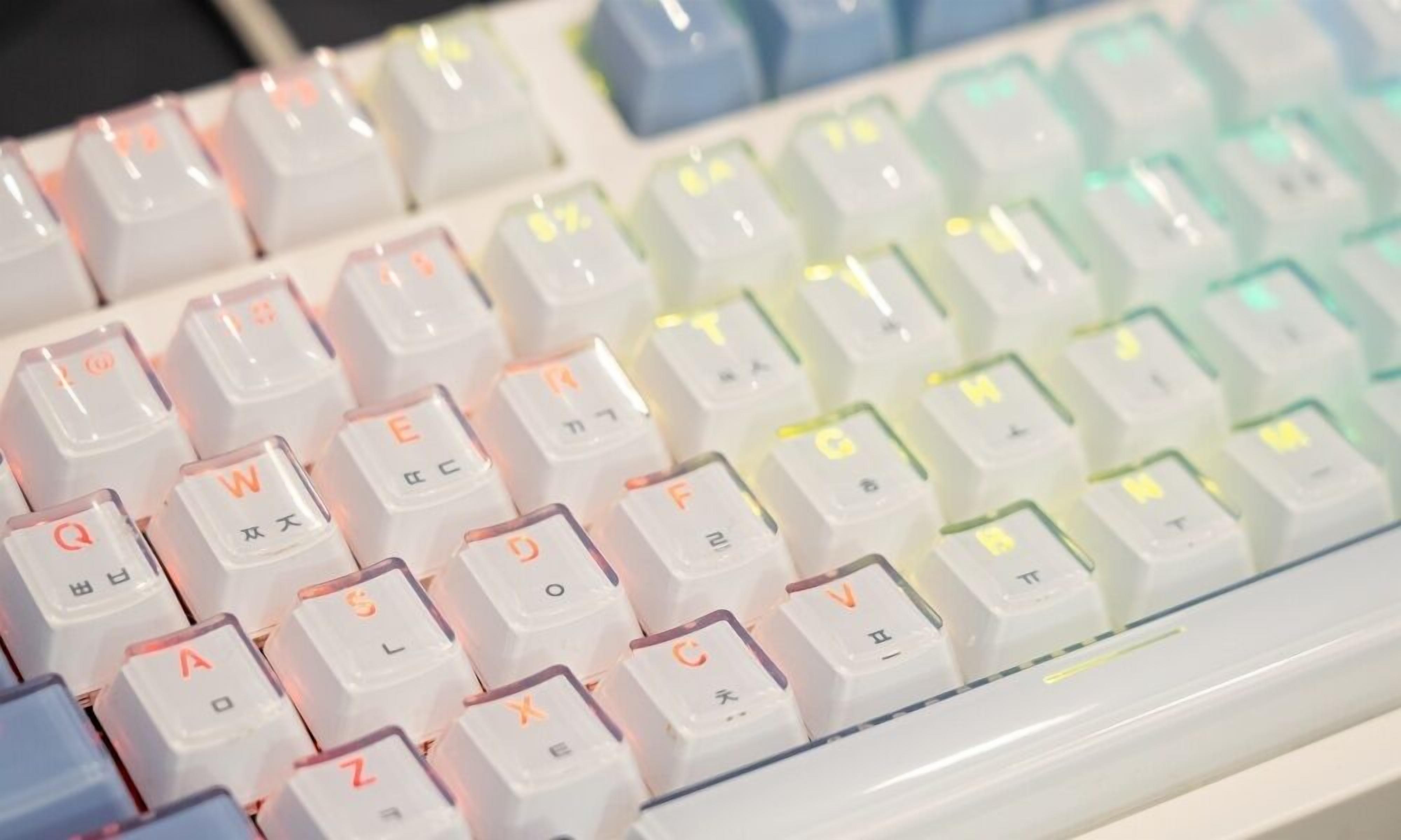 A keyboard with white keys and colorful backlighting.