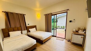 A hotel room with two beds, a small kitchenette, and a sliding glass door leading to an outdoor area. - Wangnue Mountain View Resort&Hotel (Wang Nuea)