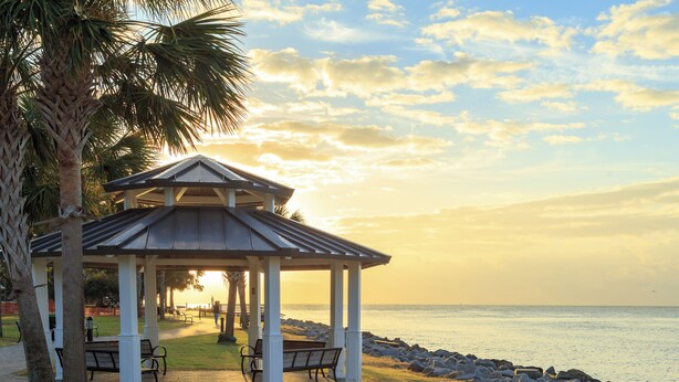 A gazebo with benches, palm trees, and a view of the ocean at sunset. - Beautiful home with modern conveniences - close to the beach, dogs welcome (St. Simons Island)