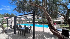 An outdoor pool area with a covered seating area and umbrellas. - Borgo Primizia B5 Pool And Sea, Otranto, Italy (Otranto)