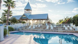 A swimming pool with lounge chairs and a gazebo structure. - Luxury cottage with pools & multiple decks, 1/2 block to beach (St. Simons Island)