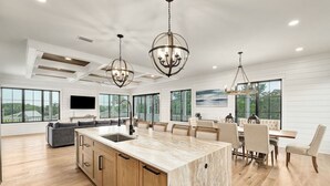 A spacious kitchen with a large island, wooden cabinets, and pendant lighting. - GULF VIEWS! Game Room, Private Pool, LSV/Golf Cart, Bikes! Sleeps 24 (Rosemary Beach)