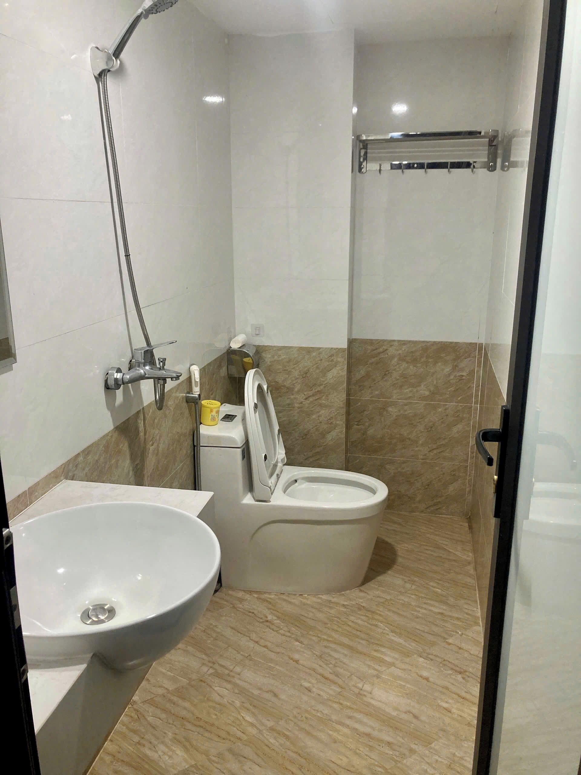 A bathroom with a sink, toilet, and shower.