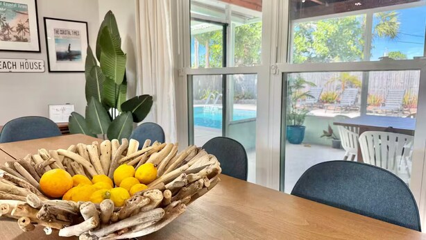 A wooden table with a woven basket containing lemons and ginger roots. - Palm Villa - 4 Bed, 2.5 Bath, Heated Pool, Hot Tub, Blocks to Beach, Sleeps 10+ (Satellite Beach)