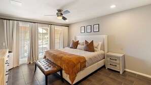 A bedroom with a bed, a bench, a nightstand, a ceiling fan, and a window with curtains. - Bright & Modern 3BR House • Steps to Old Town Scottsdale (Scottsdale)