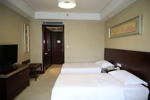 A hotel room with two beds, a television, a desk, and a framed picture on the wall. - Xikang Hotel (Nanjing)