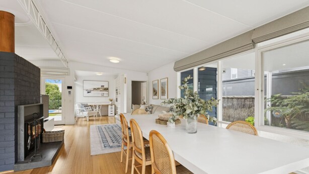 A modern kitchen with a large island, wooden flooring, and a view of the outdoors. - La Plage Portsea Escape with Pool (Portsea)